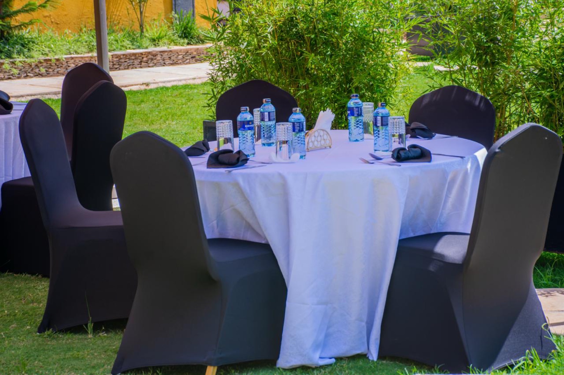 Round tables dressed for a celebration in the garden